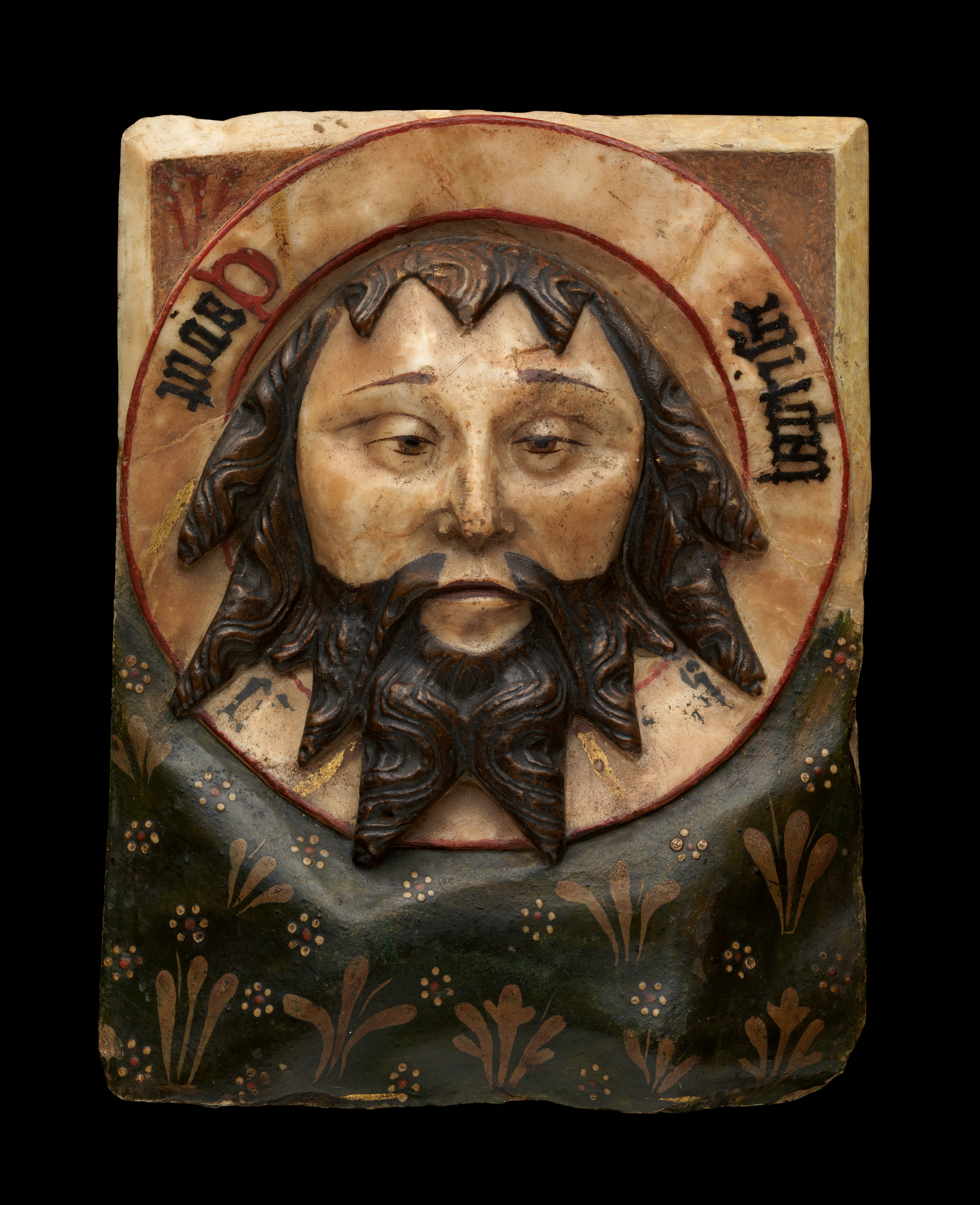 Fifteenth-century painted alabaster plaque showing the head of Saint John the Baptist on a charger