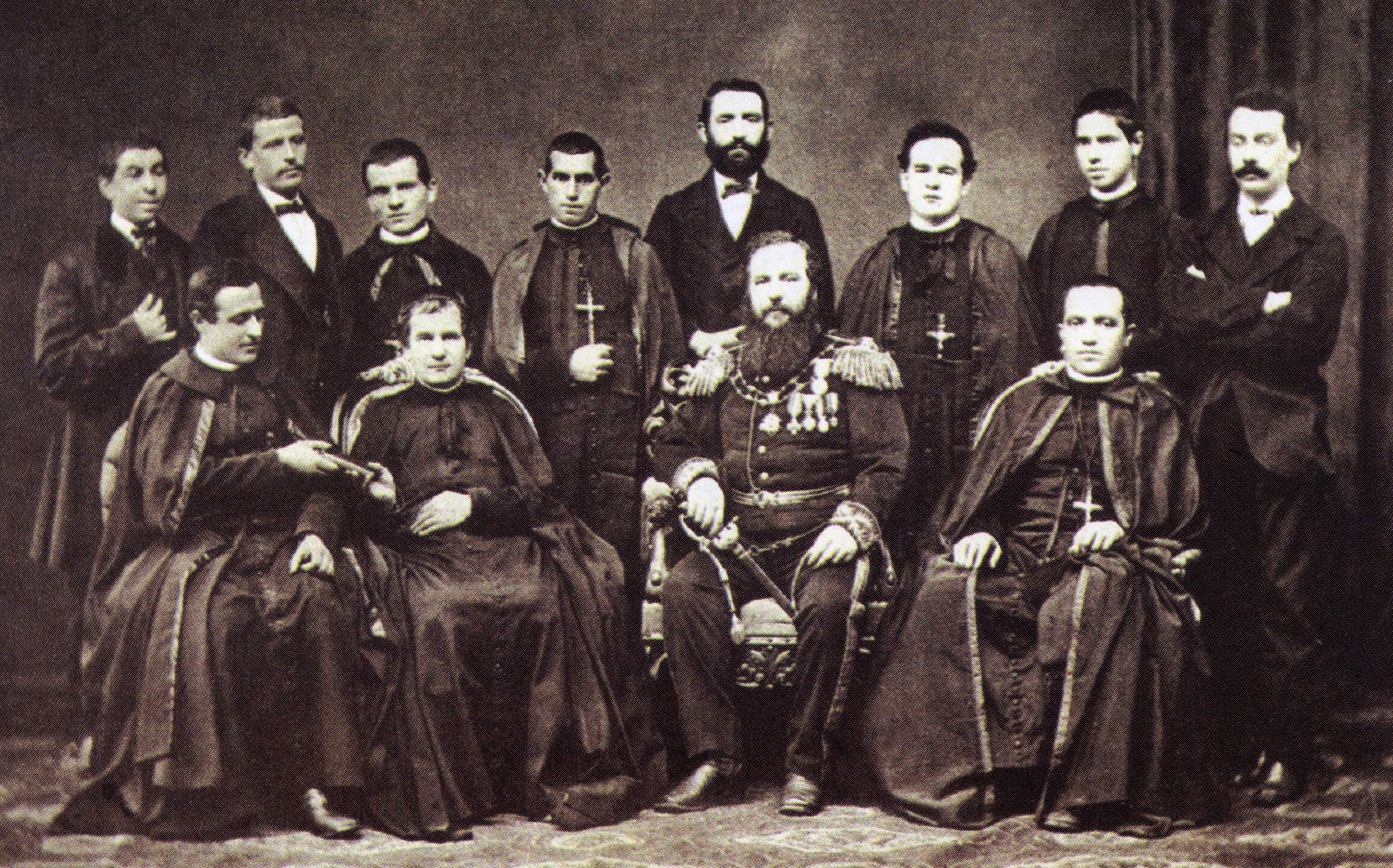 John Bosco seated with Giovanni Cagliero, Giovanni Battista Gazzolo, and members of the first Salesian missionary expedition in 1875