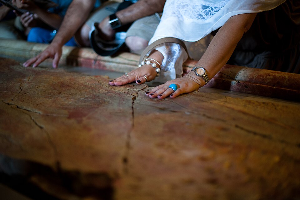 Visitors touch the Stone of Anointing at the entrance to the Church of the Holy Sepulchre in Jerusalem, photographed in 2011.
