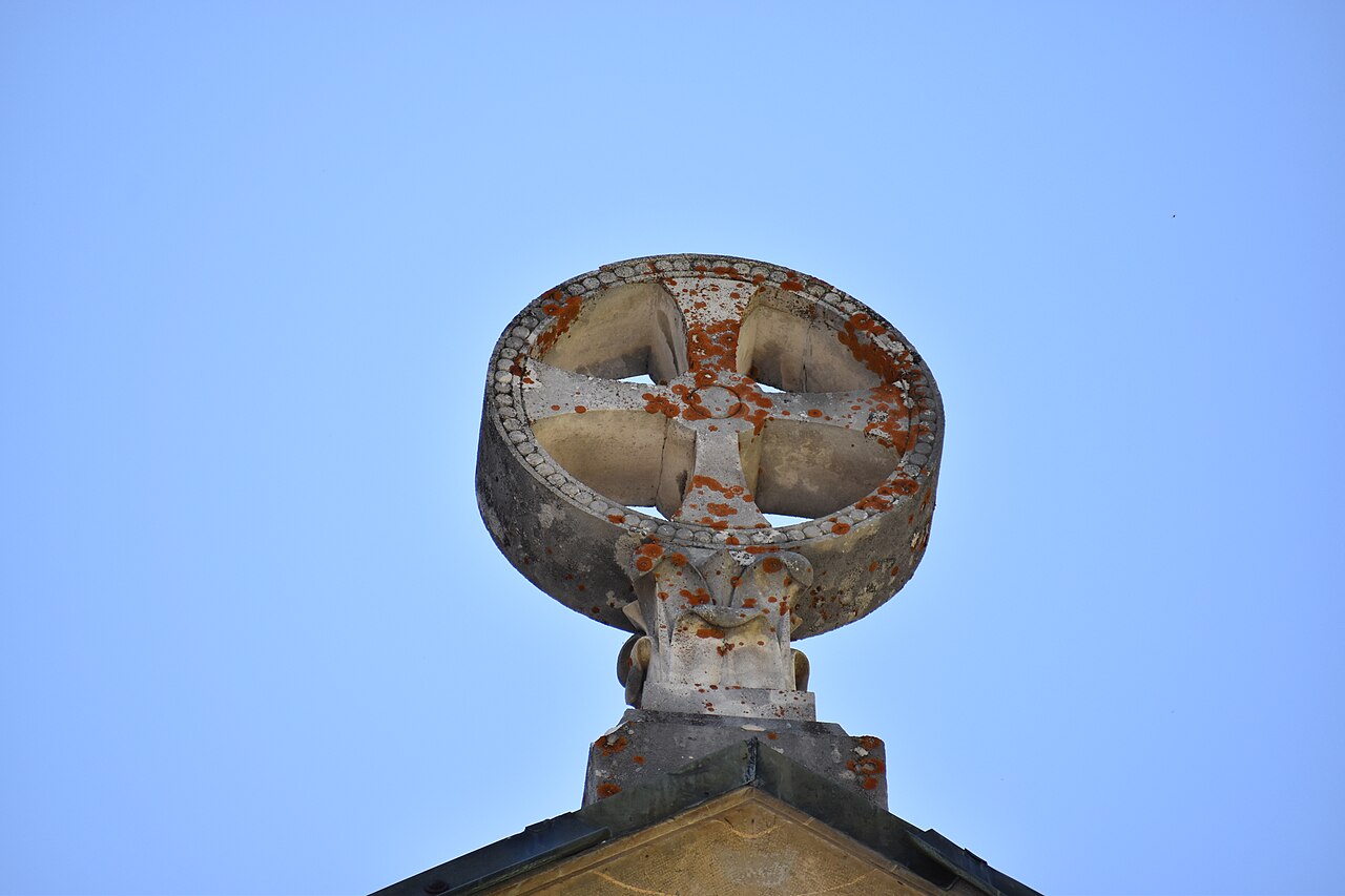 A carved cross on the exterior of the Basilica of Notre-Dame de La Salette