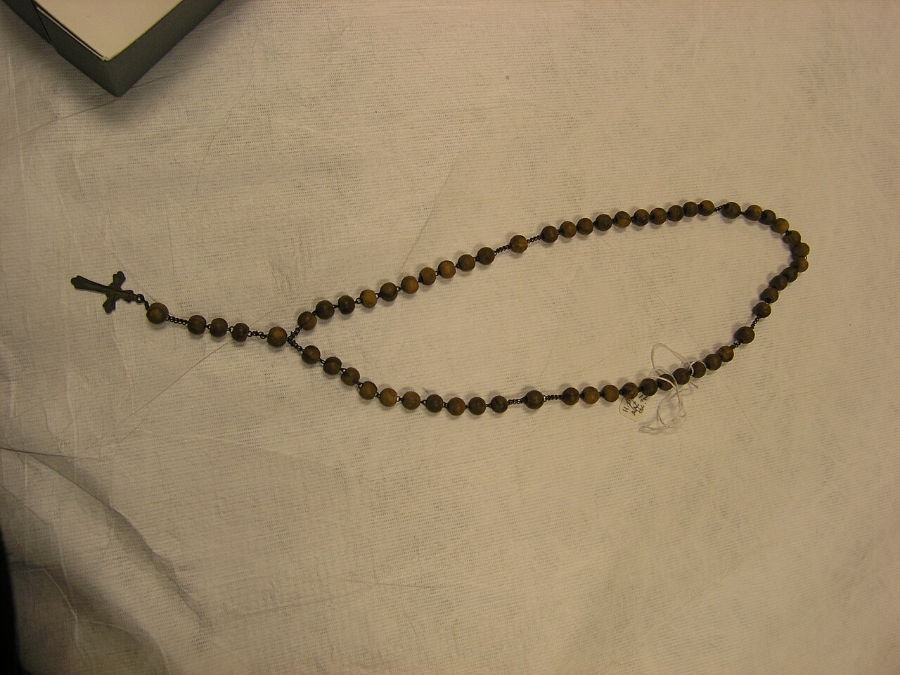 A wood-and-metal rosary with a cross, preserved in the Auckland Museum collection